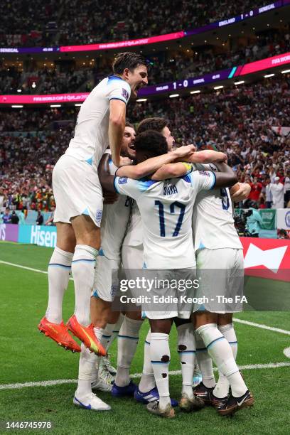 Harry Kane of England celebrates with teammates after scoring the team's second goal during the FIFA World Cup Qatar 2022 Round of 16 match between...