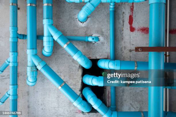 blue pipes on wall - water supply stock-fotos und bilder