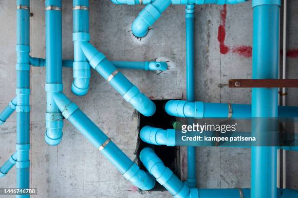blue pipes on wall - water pipe stock pictures, royalty-free photos & images