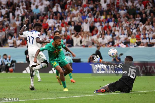 Bukayo Saka of England scores the team's third goal past Ismail Jakobs of Senegal during the FIFA World Cup Qatar 2022 Round of 16 match between...