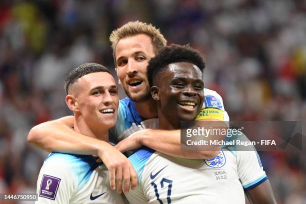 Bukayo Saka of England celebrates with Phil Foden and Harry Kane after scoring the team's third goal during the FIFA World Cup Qatar 2022 Round of 16...