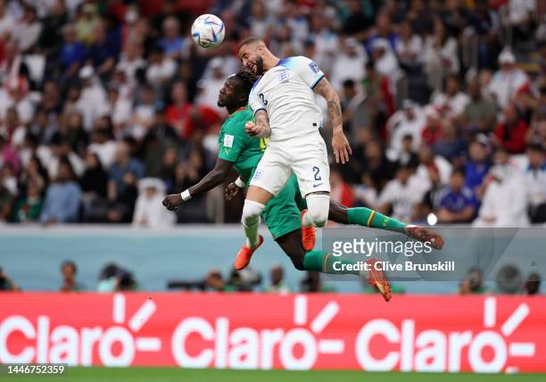 Famara Diedhiou of Senegal and Kyle Walker of England compete for the ball during the FIFA World Cup Qatar 2022 Round of 16 match between England and...