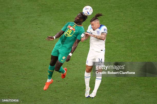 Famara Diedhiou of Senegal jumps for the ball with Kalvin Phillips of England during the FIFA World Cup Qatar 2022 Round of 16 match between England...