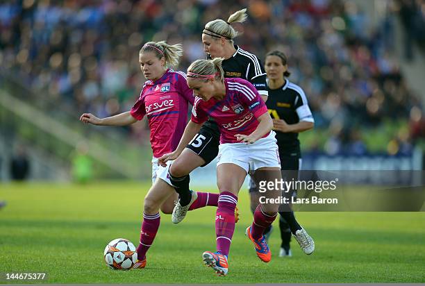 Svenja Huth of Frankfurt is challenged by Eugenie Le Sommer and Amandine Henry of Olympique Lyonnais during the UEFA Women's Champions League Final...