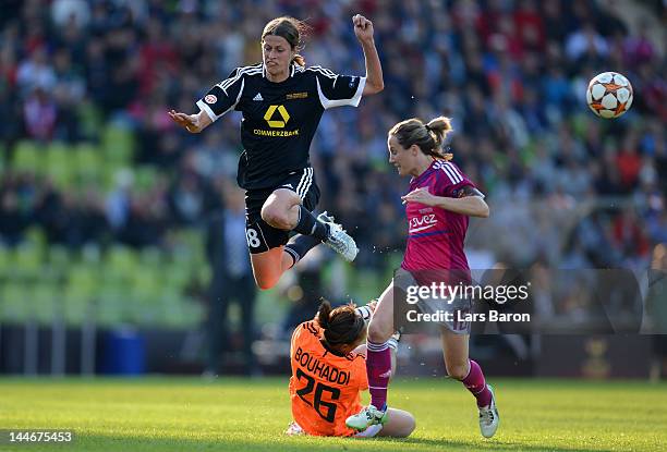 Kerstin Garefrekes of Frankfurt jumps over goalkeeper Sarah Bouhaddi of Lyon next to Sonia Bompastor of Lyon during the UEFA Women's Champions League...