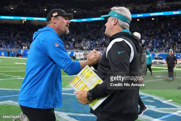 Head coach Dan Campbell of the Detroit Lions shakes hands with head coach Doug Pederson of the Jacksonville Jaguars on the field after the game at...