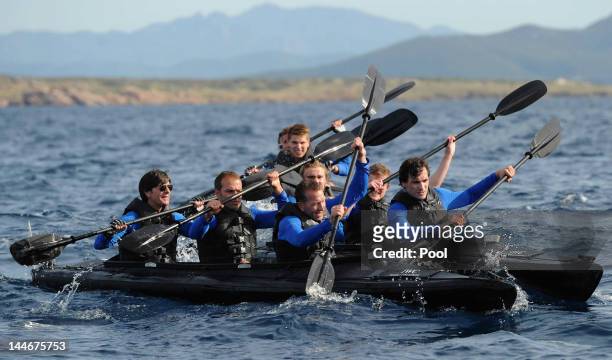 Goalkeeper coach Andreas Koepke, assistant coach Hans-Dieter Flick and Head coach Joachim Loew comepete during a boat race of the German national...