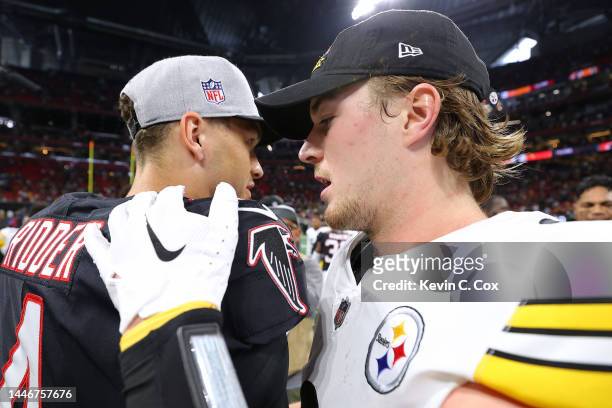 Desmond Ridder of the Atlanta Falcons and Kenny Pickett of the Pittsburgh Steelers hug on the field after the game at Mercedes-Benz Stadium on...