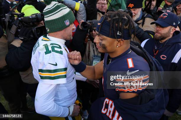 Aaron Rodgers of the Green Bay Packers and Justin Fields of the Chicago Bears meet on the field after their game at Soldier Field on December 04,...