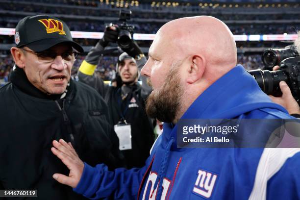 Head coach Brian Daboll of the New York Giants and head coach Ron Rivera of the Washington Commanders meet a midfield after the game at MetLife...
