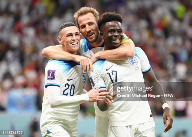 Bukayo Saka of England celebrates with Phil Foden and Harry Kane after scoring the team's third goal during the FIFA World Cup Qatar 2022 Round of 16...