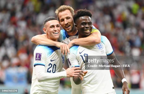 Bukayo Saka of England celebrates with Phil Foden and Harry Kane after scoring the team's third goal during the FIFA World Cup Qatar 2022 Round of 16...
