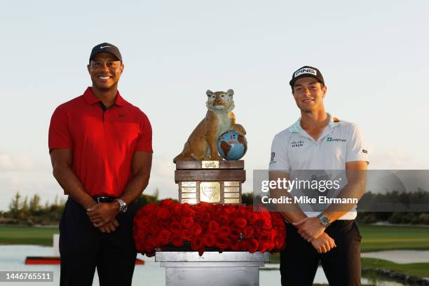 Viktor Hovland of Norway celebrates with the trophy and Tiger Woods of the United States after winning during the final round Hero World Challenge at...