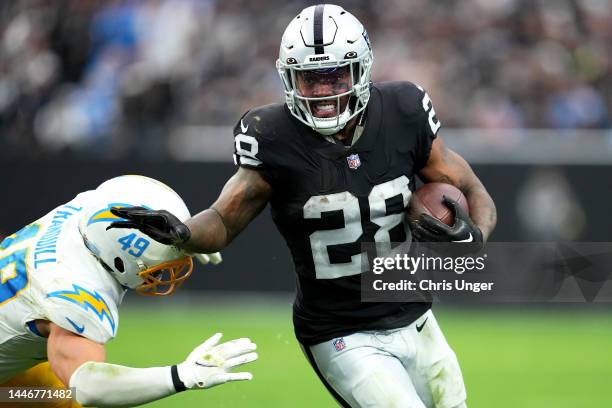 Josh Jacobs of the Las Vegas Raiders runs with the ball in the second quarter of a game against the Los Angeles Chargers at Allegiant Stadium on...
