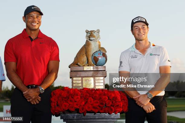 Viktor Hovland of Norway celebrates with the trophy and host Tiger Woods after winning during the final round Hero World Challenge at Albany Golf...