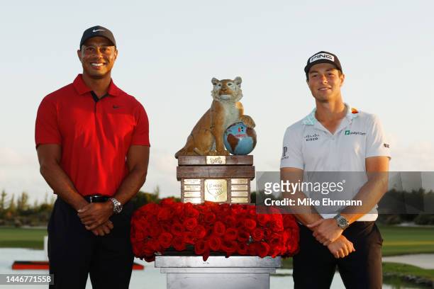 Viktor Hovland of Norway celebrates with the trophy and host Tiger Woods after winning during the final round Hero World Challenge at Albany Golf...