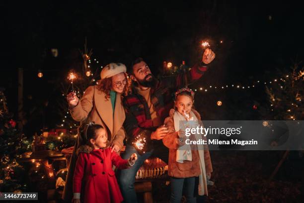 young girls having the best time at christmas with their parents - christmas background no people stock pictures, royalty-free photos & images