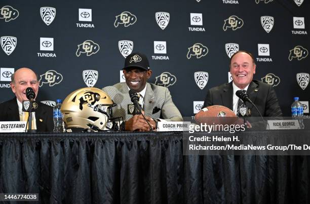 Deion Sanders, CUs new head football coach, flanked by CU Chancellor Phil DiStefano, left, and athletic director Rick George, right, takes questions...