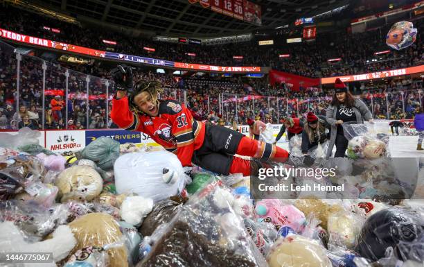 London Hoilett of the Calgary Hitmen jumps into a pile of plush toys after scoring on the Moose Jaw Warriors during the 27th annual ENMAX Teddy Bear...