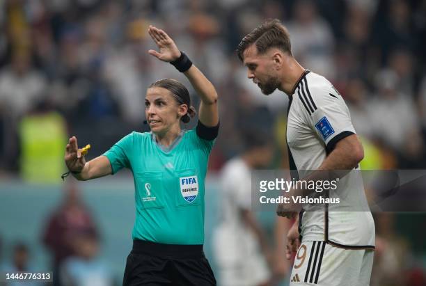 Referee Stephanie Frappart talks to Niclas Fullkrug of Germany during the FIFA World Cup Qatar 2022 Group E match between Costa Rica and Germany at...