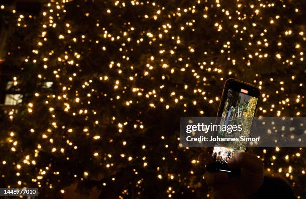 Giant christmas trees is illuminated with several hundred electric bulbs on the 2nd weekend of the Munich central Christmas market at Marienplatz...