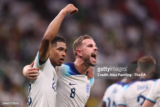 Jordan Henderson of England celebrates with team mate Jude Bellingham after scoring his sides first goal during the FIFA World Cup Qatar 2022 Round...