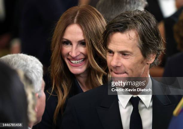 Actress Julia Roberts and her husband cinematographer Daniel Moder talk to Dr. Anthony Fauci during a reception for the 2022 Kennedy Center honorees...