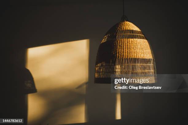 handmade wicker rattan chandelier hanging at home in beautiful morning light - ceiling lamp stock pictures, royalty-free photos & images