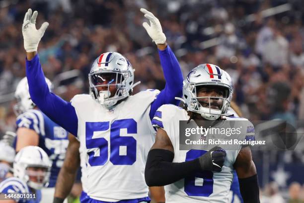 Donovan Wilson and Dante Fowler Jr. #56 of the Dallas Cowboys celebrate after a sack in the second quarter at AT&T Stadium on December 04, 2022 in...