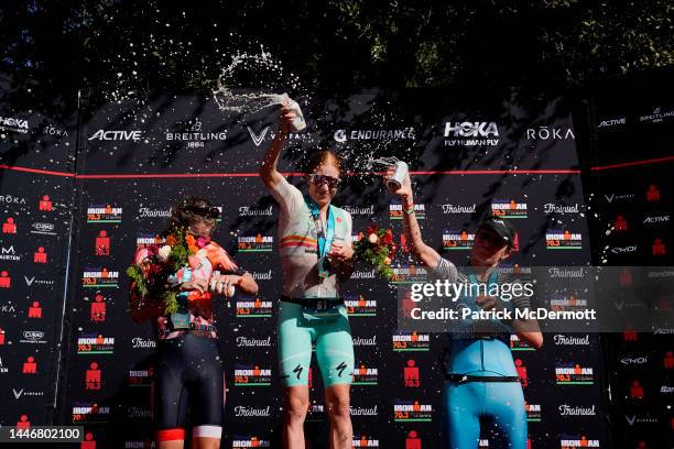 Tamara Jewett of Canada, Paula Findlay of Canada, and Danielle Lewis of the United States celebrate on the podium at IRONMAN 70.3 Indian Wells - La...