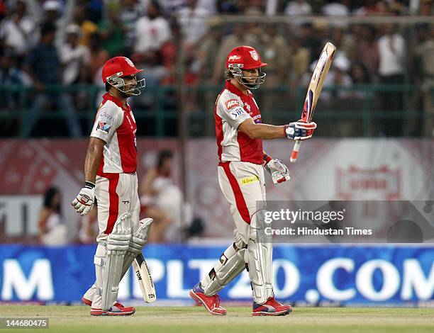 Kings XI Punjab batsman Adam Gilchrist raises his bat to celebrate his fifty during IPL Twenty 20 cricket match between Kings XI Punjab and Chennai...