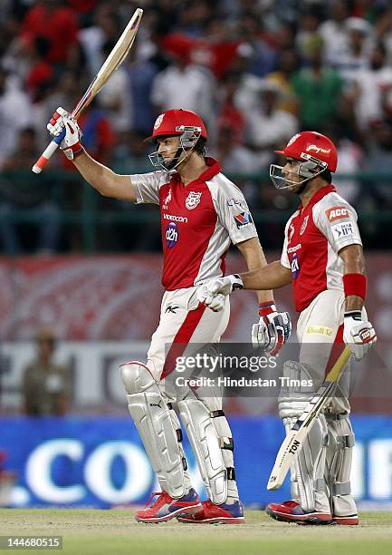 Kings XI Punjab batsman Adam Gilchrist raises his bat to celebrate his fifty during IPL Twenty 20 cricket match between Kings XI Punjab and Chennai...