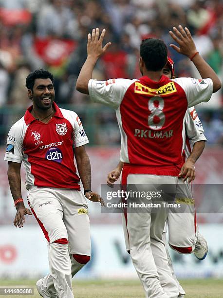 Kings XI Punjab bowler Parvinder Awana celebrates with teammates after the dismissal of Chennai Super Kings batsman MS Dhoni during IPL Twenty 20...