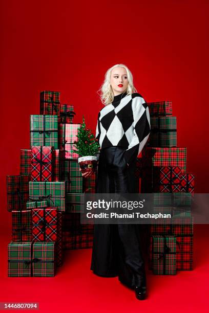 beautiful woman holding christmas tree - pile of gifts stock pictures, royalty-free photos & images