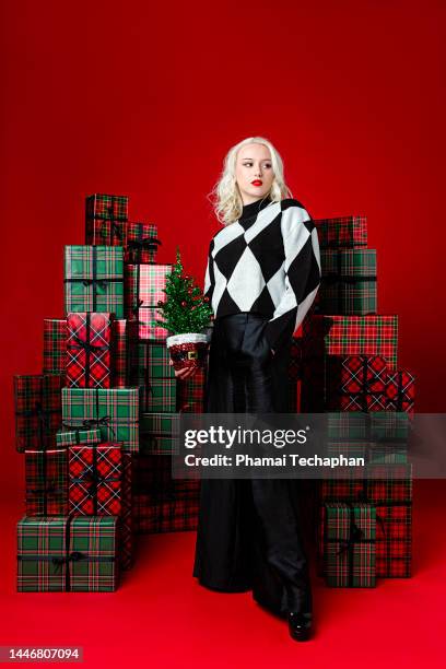 beautiful woman holding christmas tree - cool christmas stock pictures, royalty-free photos & images