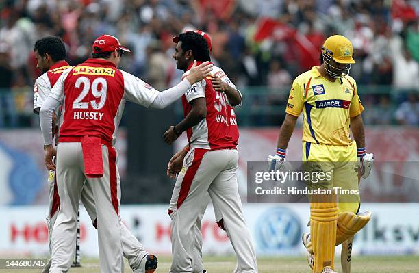 Kings XI Punjab bowler Parvinder Awana celebrates with teammates after the dismissal of Chennai Super Kings batsman MS Dhoni during IPL Twenty 20...