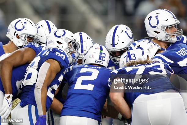 The Indianapolis Colts huddle in the first half of a game against the Dallas Cowboys at AT&T Stadium on December 04, 2022 in Arlington, Texas.