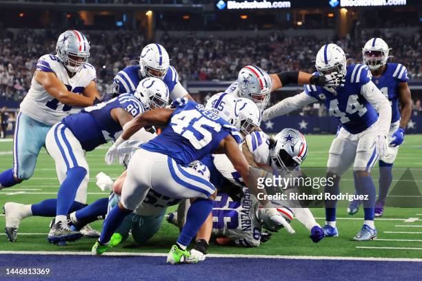 Ezekiel Elliott of the Dallas Cowboys scores a touchdown in the fourth quarter of a game against the Indianapolis Colts at AT&T Stadium on December...