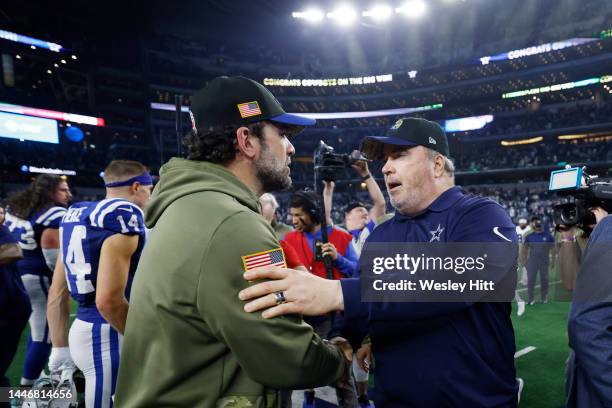 Head coach Mike McCarthy of the Dallas Cowboys and head coach Jeff Saturday of the Indianapolis Colts shake hands after a game at AT&T Stadium on...