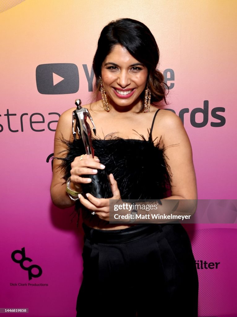 Sheena Melwani poses with and award during the 2022 YouTube Streamy
