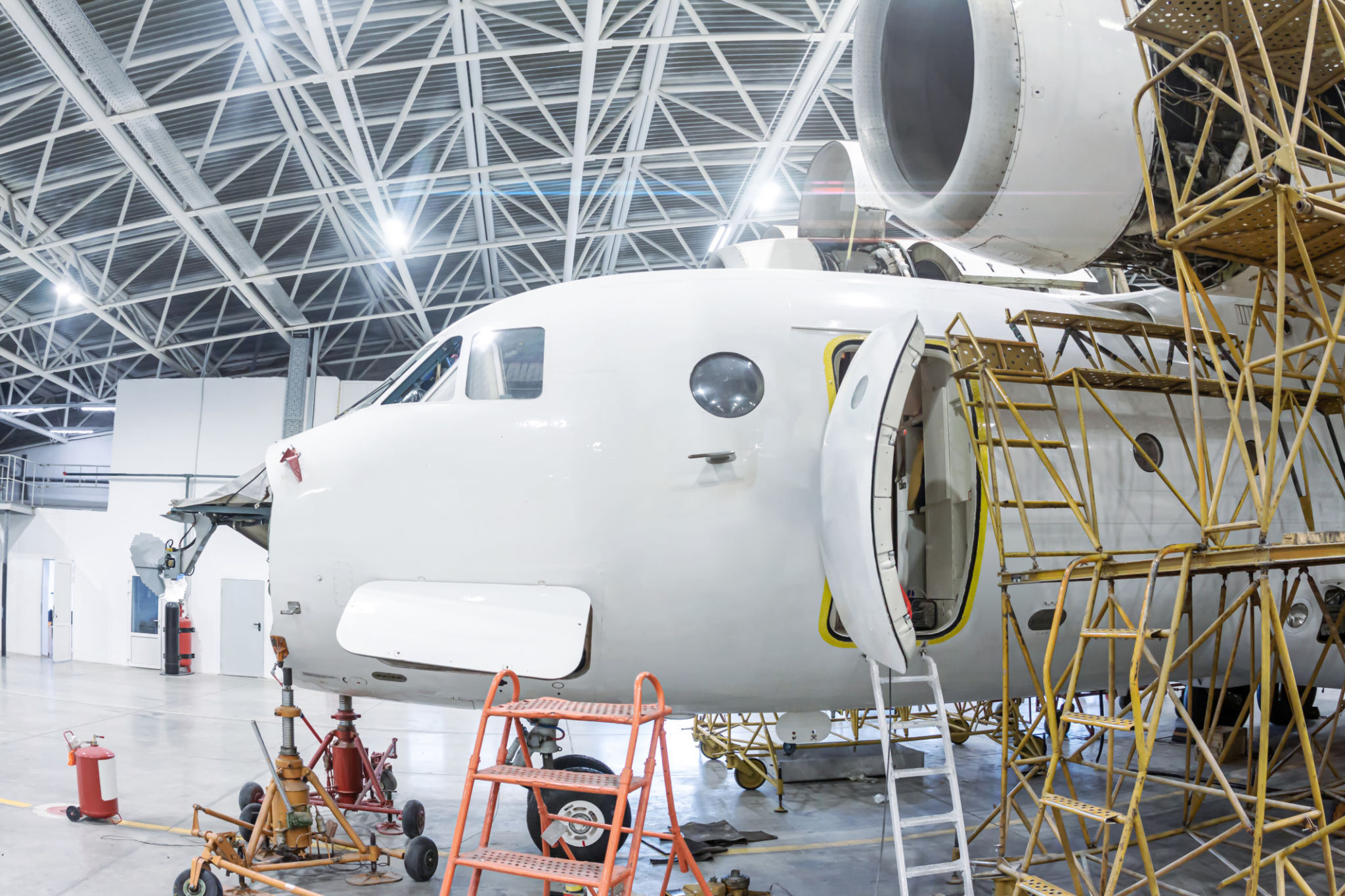 Close-up white transport airplane in the hangar Close-up white transport airplane in the hangar