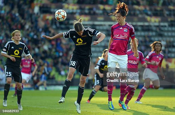 Lotta Schelin of Lyon goes up for a header with Kerstin Garefrekes of Frankfurt during the UEFA Women's Champions League Final between Olympique...