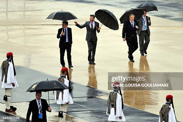 London Mayor Boris Johnson and British football player David Beckam attend the Olympic Flame handover ceremony at the Athens' all marble Panathenaic...