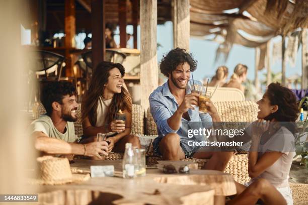 happy couples enjoying in summer day in a beach bar. - cold drink beach stock pictures, royalty-free photos & images