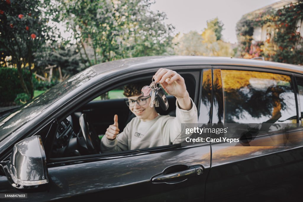 Boy inside car with new driving license