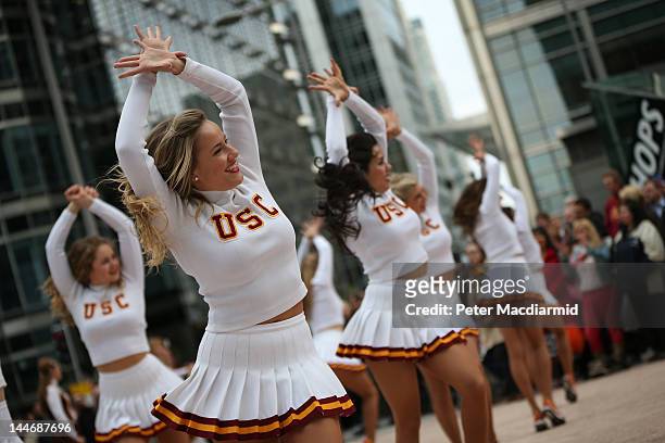 Cheerleaders of the University Of Southern California Trojan Band perform at Canary Wharf on May 17, 2012 in London, England. This is the first visit...