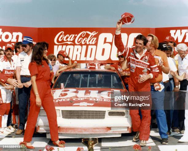 May 26, 1985: Darrell Waltrip waves his cap in victory lane at Charlotte Motor Speedway after winning the Coca-Cola World 600 NASCAR Cup race, one of...