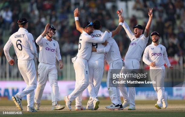 James Anderson of England celebrates with teammates after taking the wicket of Haris Rauf of Pakistan during day five of the First Test Match between...