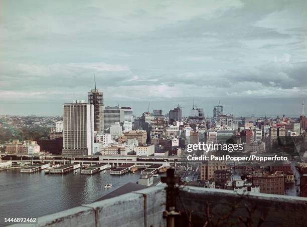 View from Sydney Harbour Bridge of the Circular Quay wharves and passenger terminal underneath the recently completed AMP Building office block in...