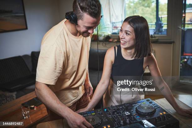 happy young woman and man operating mixing console - producer stock pictures, royalty-free photos & images